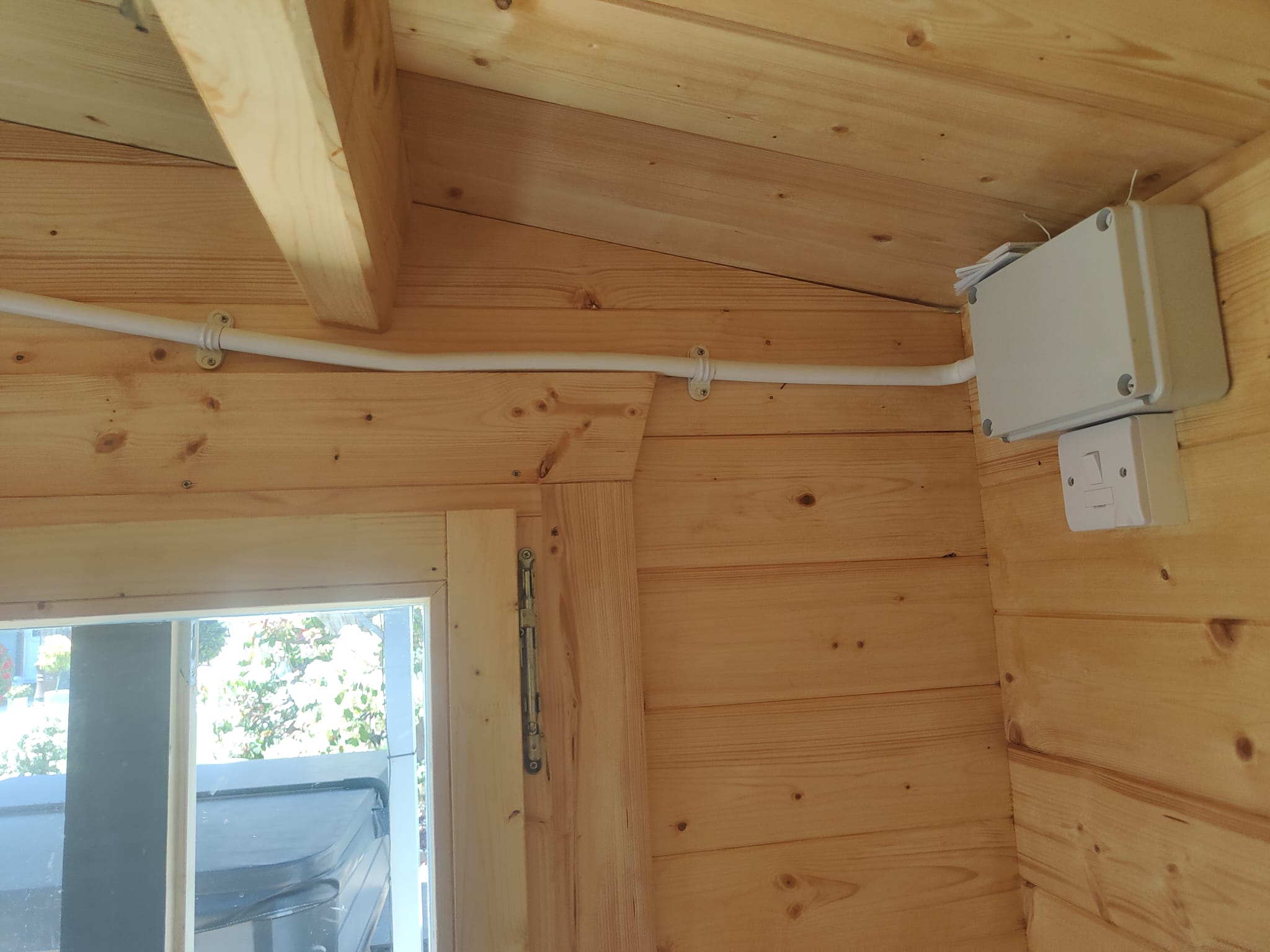 Fitting electrical conduit to a log cabin wall