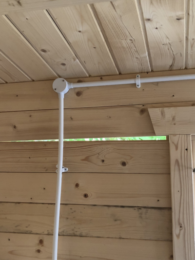 Contractors faulty fixing vertical conduit in a log cabin
