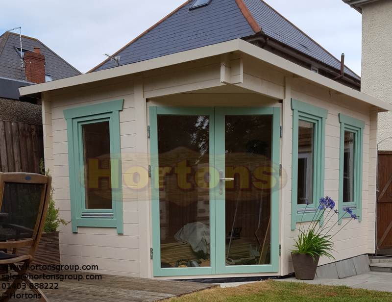 Insulated corner log cabin garden room